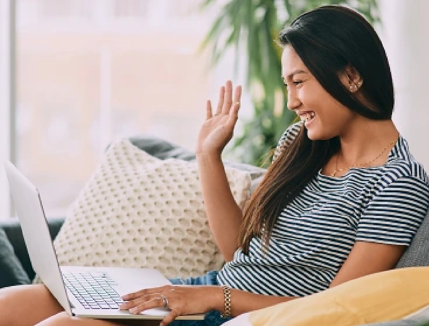 Waving hello to a stylist on a video call